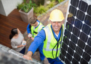 Solar Installer installing solar panel on a roof