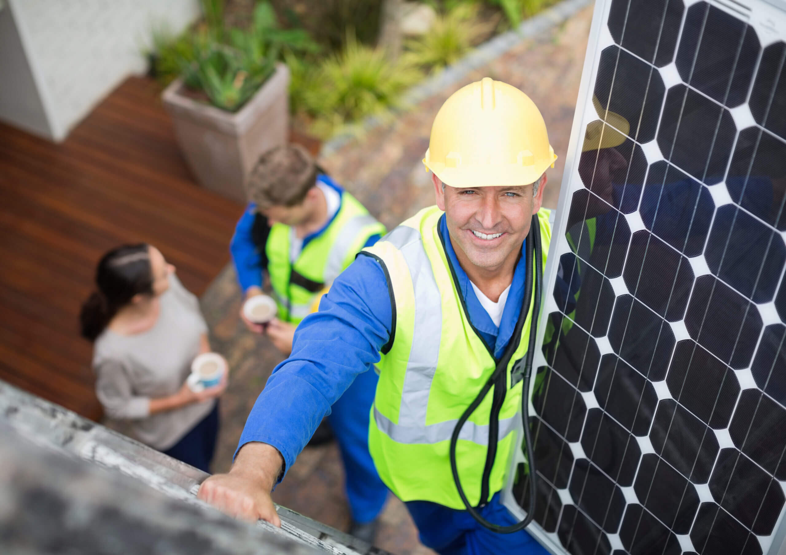 Solar Installer installing solar panel on a roof