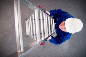 Worker looking up a ladder