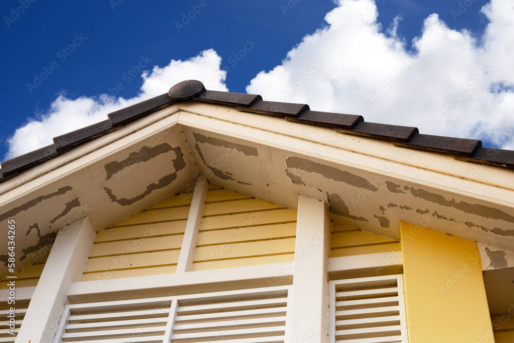 residential roof leak showing wet soffits