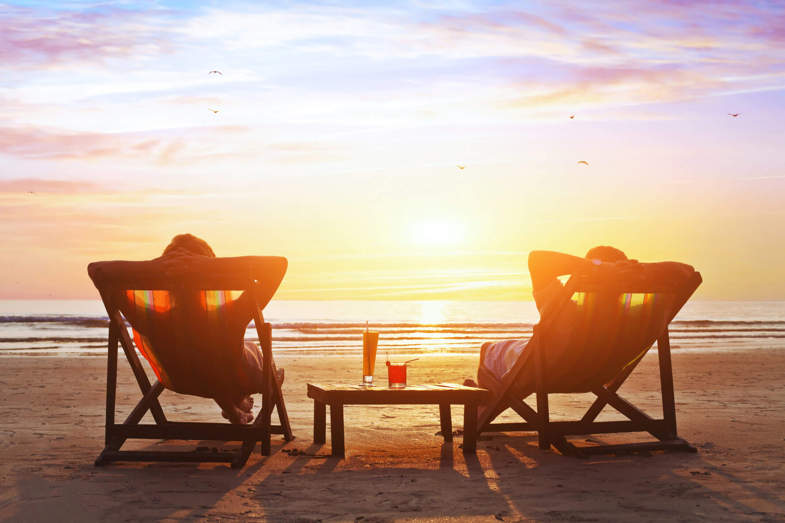 happy couple enjoy luxury sunset on the beach during summer vacations